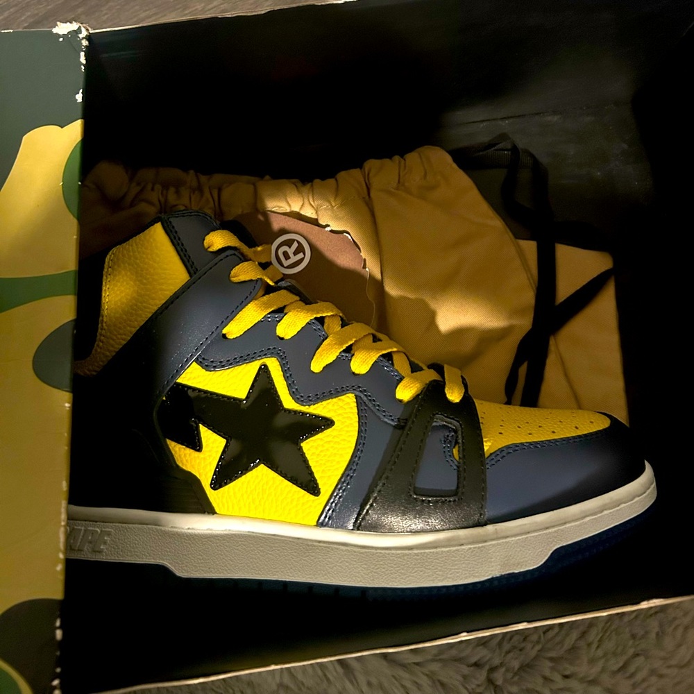 BAPE
Yellow & Navy Sta 93 Hi Sneakers. Brand new never worn.